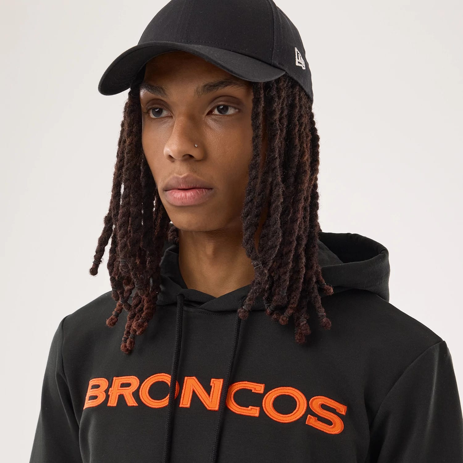The model is wearing this NFL Sideline 2026 Denver Broncos Double Sleeve Hoodie in black. 6