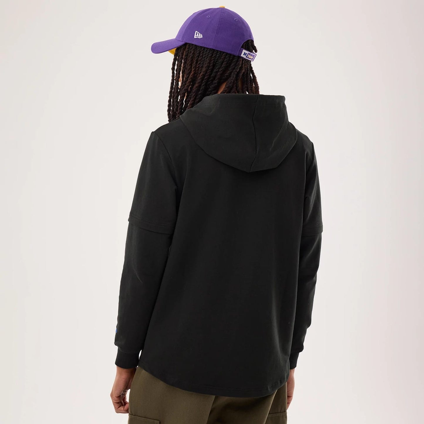 The model is wearing this NFL Sideline 2026 Minnesota Vikings Double Sleeve Hoodie in black. 2