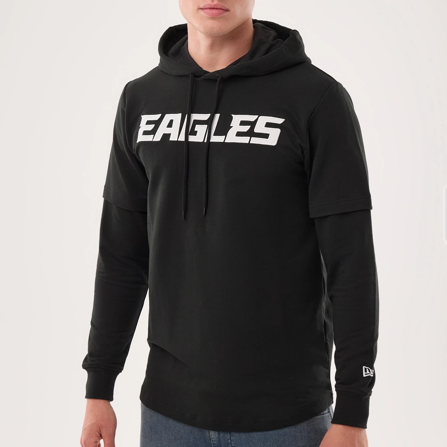 The model is wearing this NFL Sideline 2026 Philadelphia Eagles Double Sleeve Hoodie in black. 3