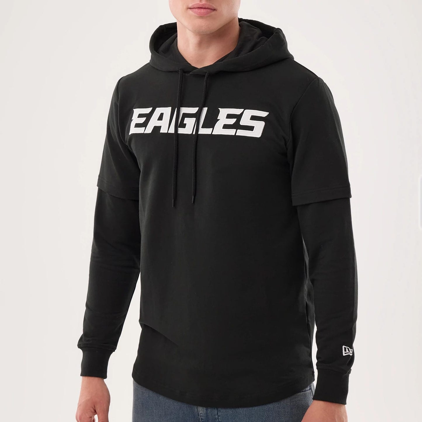 The model is wearing this NFL Sideline 2026 Philadelphia Eagles Double Sleeve Hoodie in black. 3