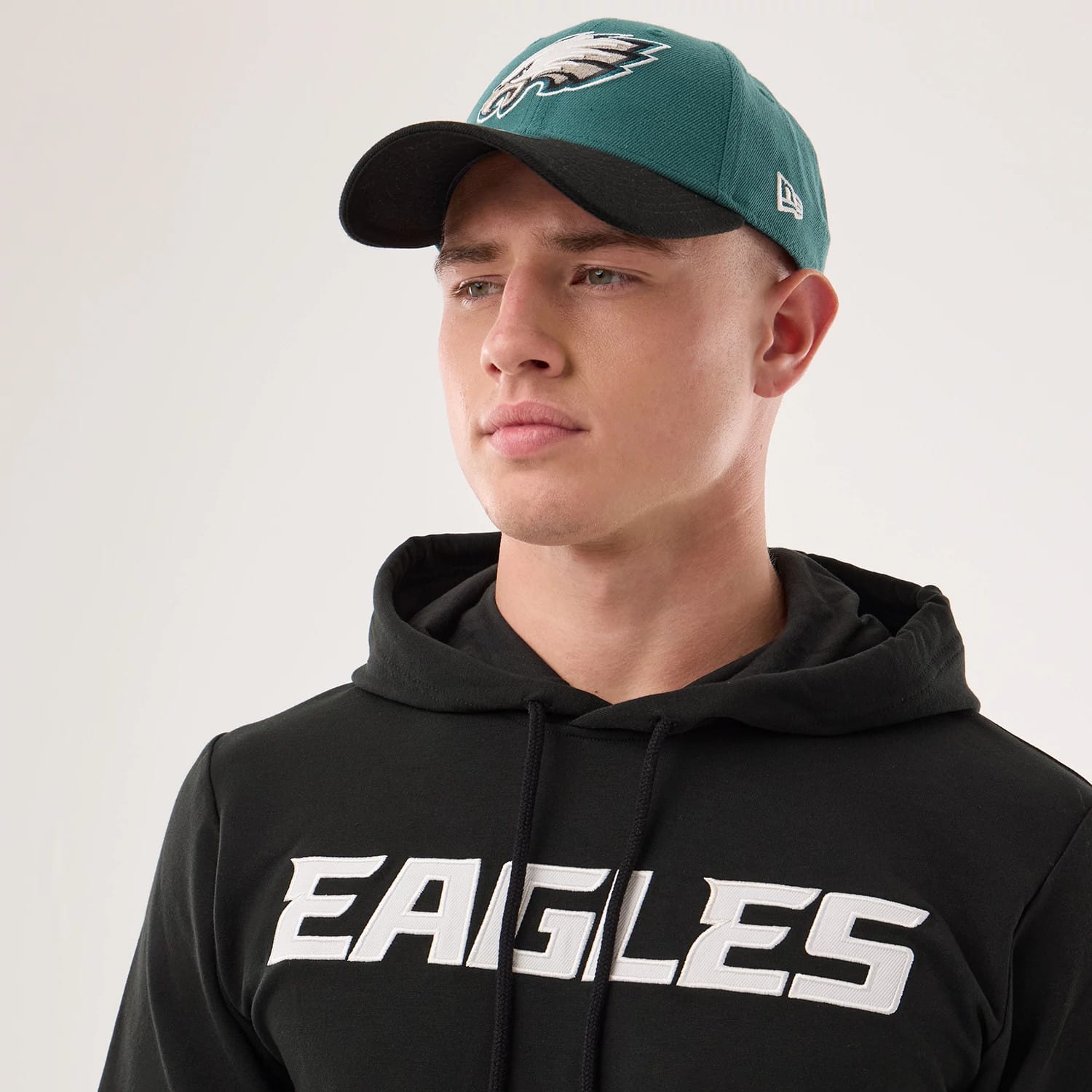 The model is wearing this NFL Sideline 2026 Philadelphia Eagles Double Sleeve Hoodie in black. 6