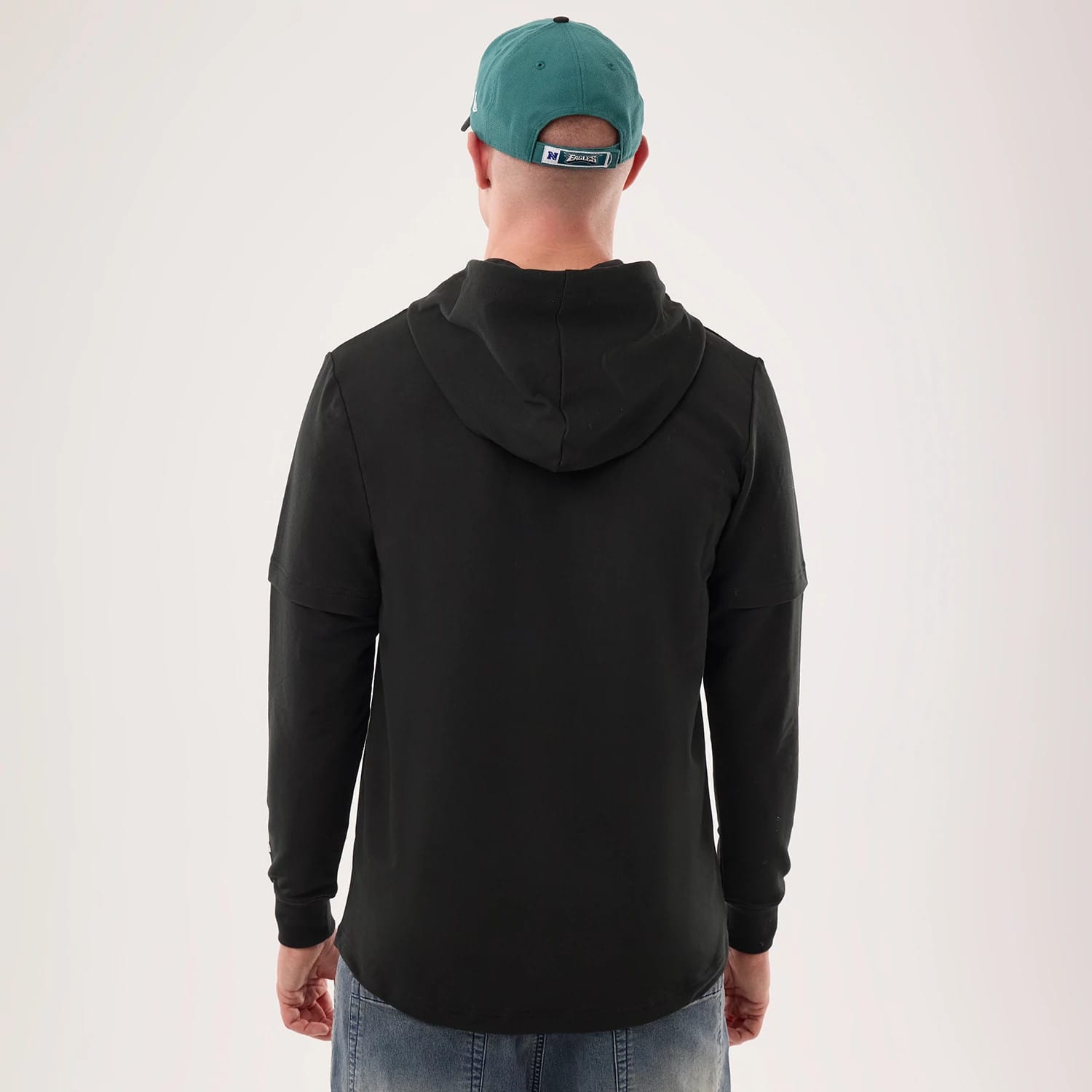 The model is wearing this NFL Sideline 2026 Philadelphia Eagles Double Sleeve Hoodie in black. 2