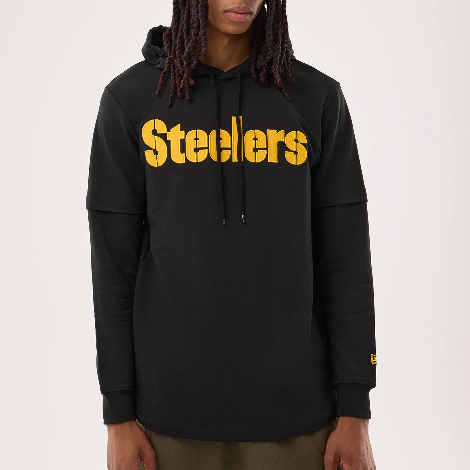 The model is wearing this NFL Sideline 2026 Pittsburgh Steelers Double Sleeve Hoodie in black. 3