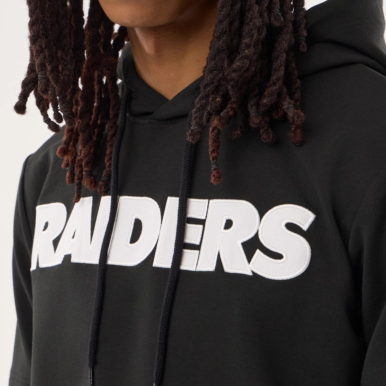 The model is wearing this NFL Sideline 2026 Las Vegas Raiders Double Sleeve Hoodie in black. 3
