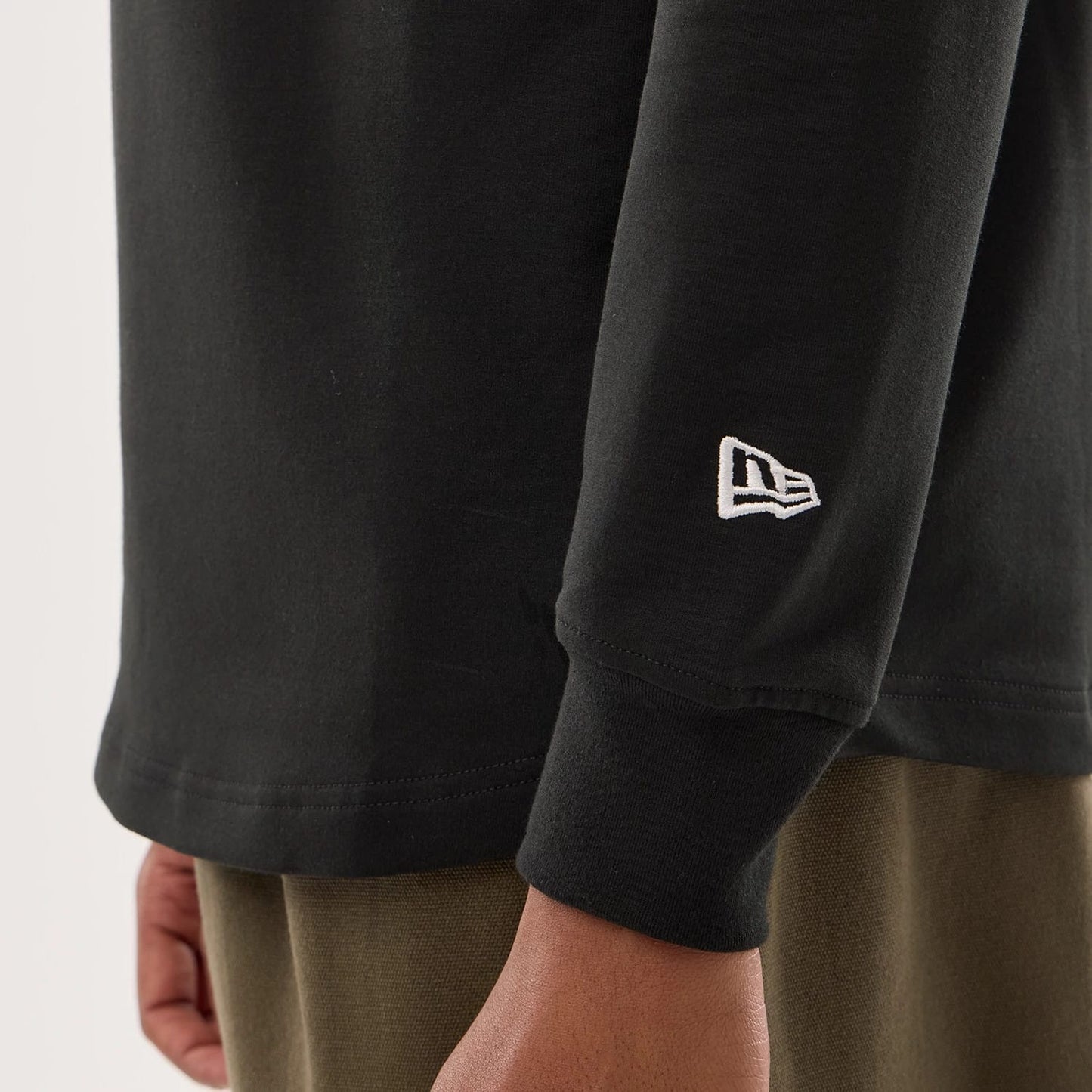 The model is wearing this NFL Sideline 2026 Las Vegas Raiders Double Sleeve Hoodie in black. 5
