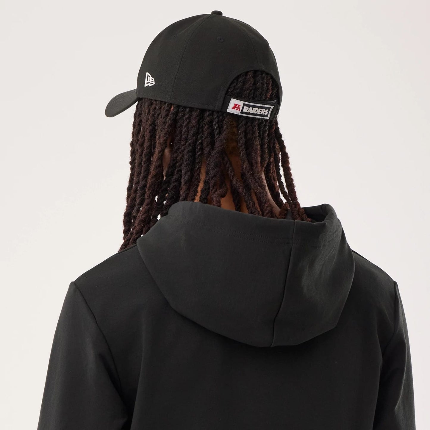 The model is wearing this NFL Sideline 2026 Las Vegas Raiders Double Sleeve Hoodie in black. 7