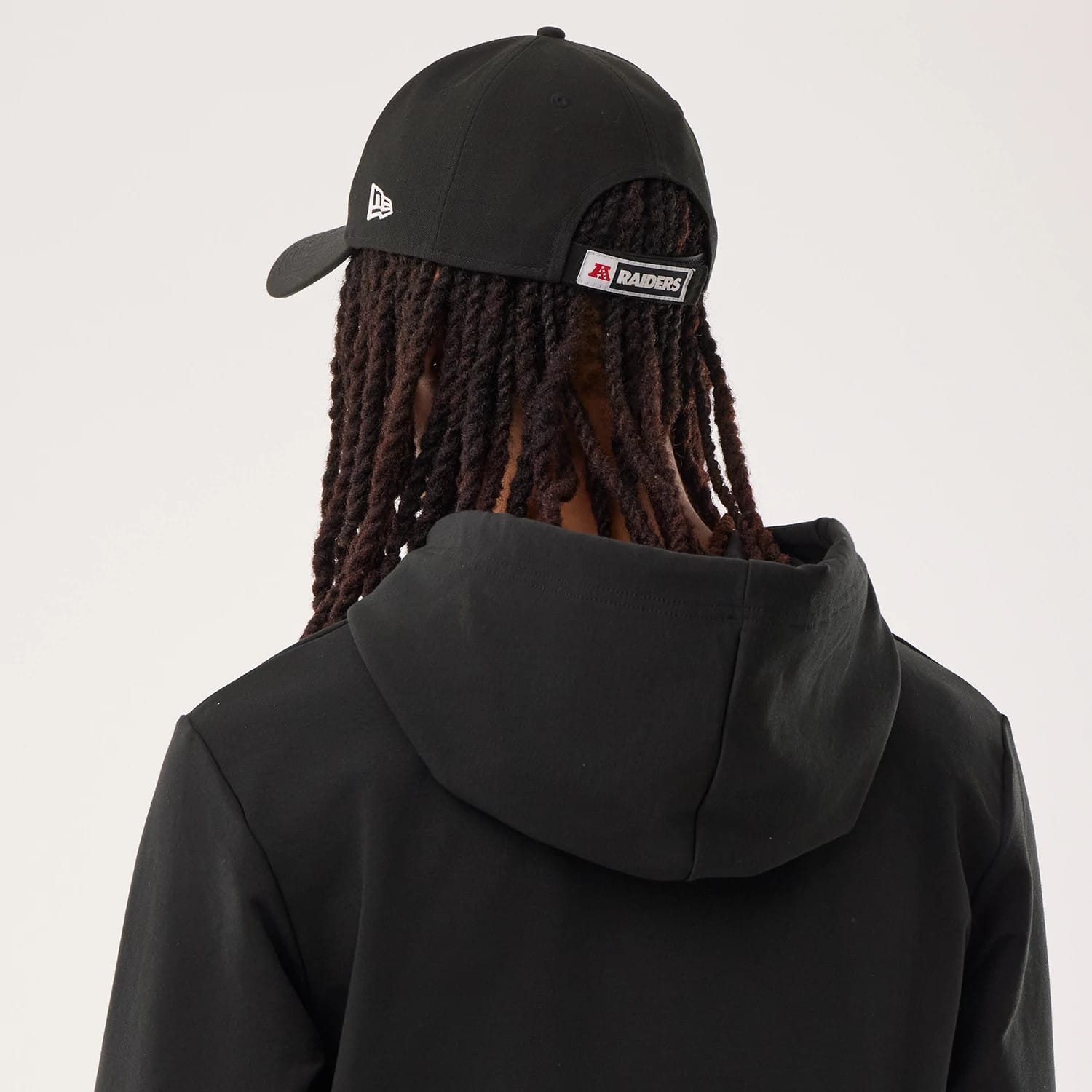 The model is wearing this NFL Sideline 2026 Las Vegas Raiders Double Sleeve Hoodie in black. 7