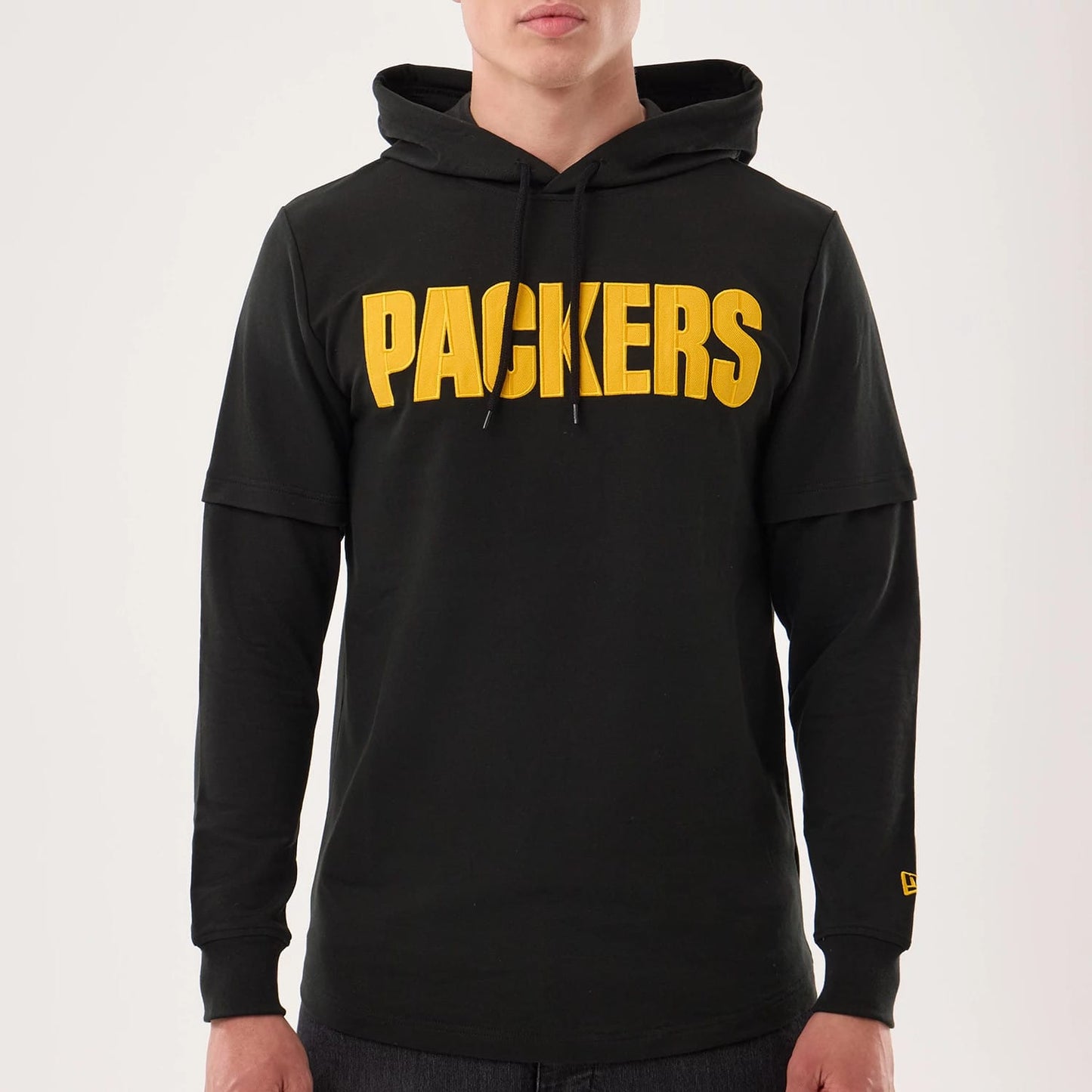 The model is wearing this NFL Sideline 2026 Green Bay Packers Double Sleeve Hoodie in black. 3