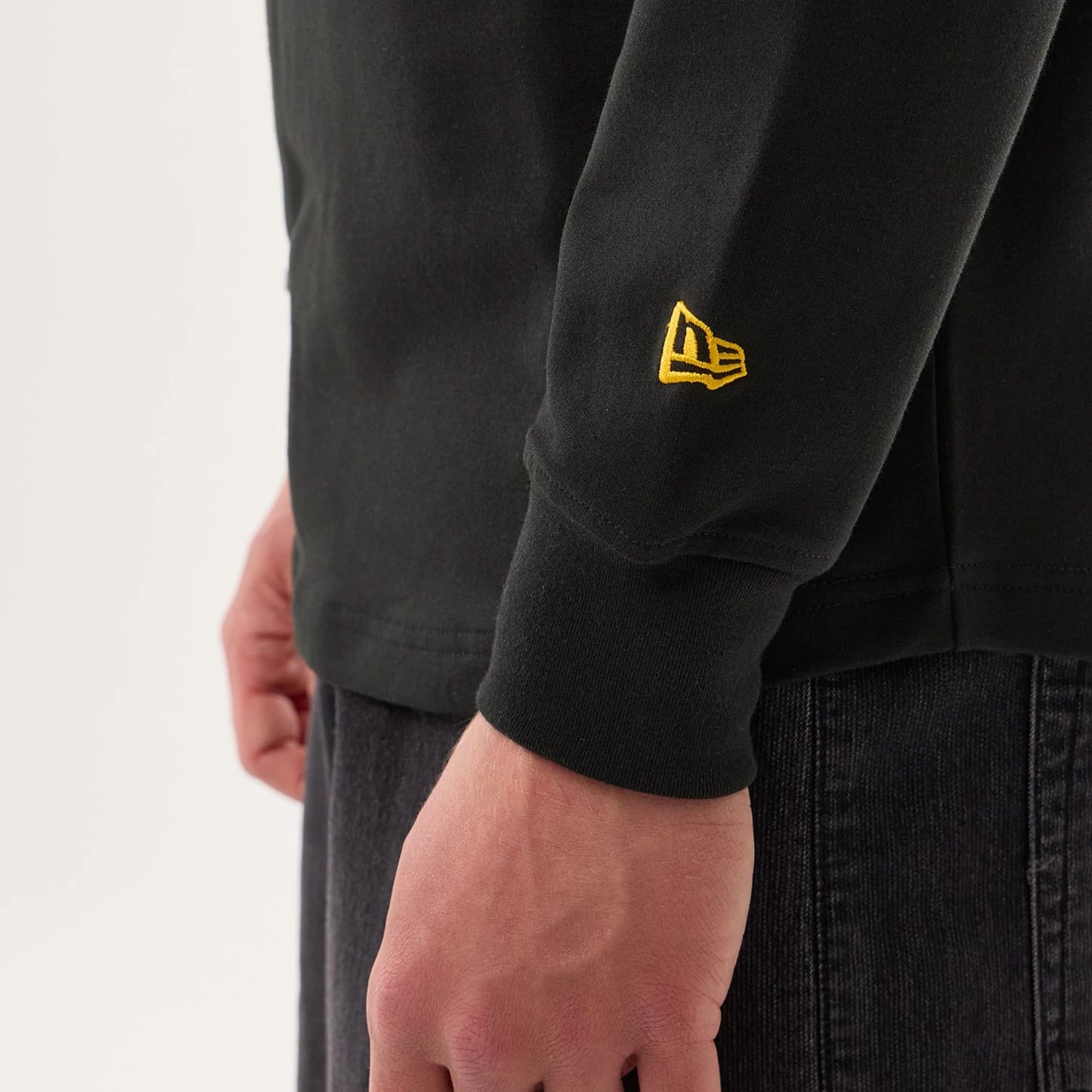 The model is wearing this NFL Sideline 2026 Green Bay Packers Double Sleeve Hoodie in black. 5