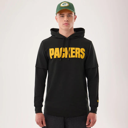 The model is wearing this NFL Sideline 2026 Green Bay Packers Double Sleeve Hoodie in black. 1