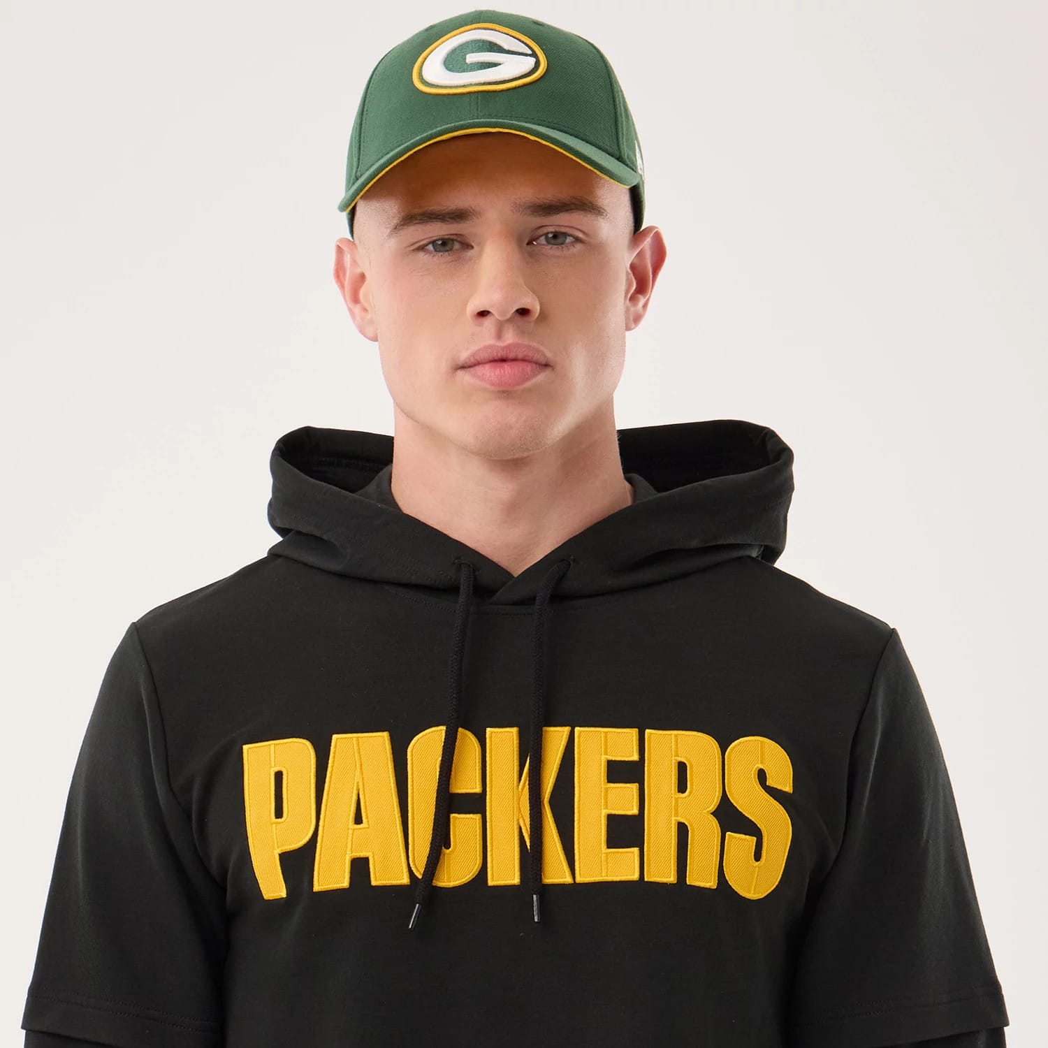 The model is wearing this NFL Sideline 2026 Green Bay Packers Double Sleeve Hoodie in black. 6