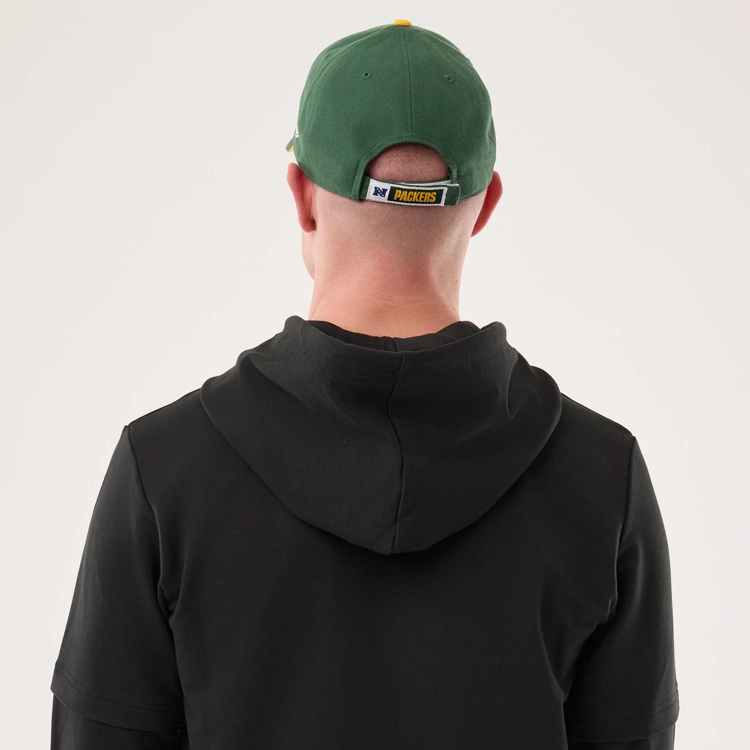 The model is wearing this NFL Sideline 2026 Green Bay Packers Double Sleeve Hoodie in black. 7
