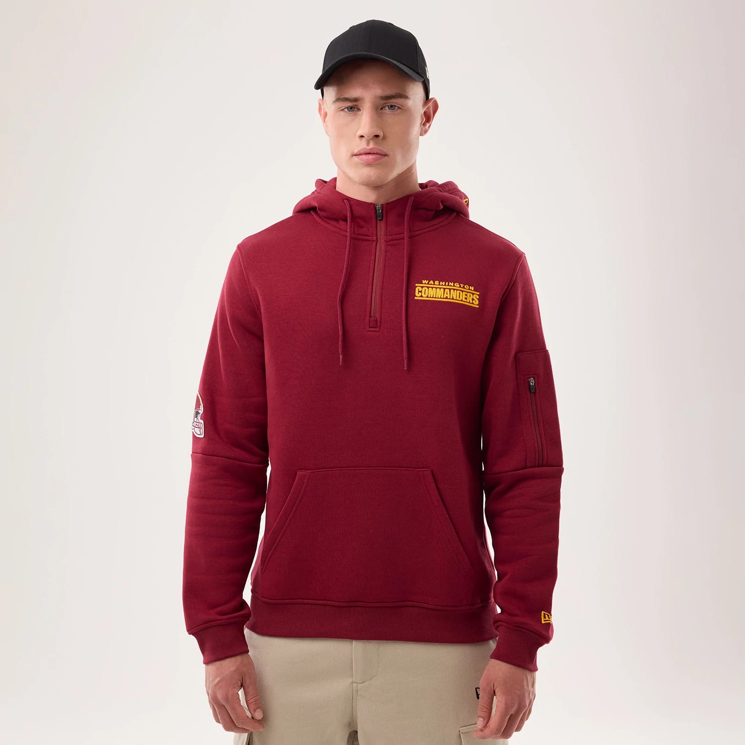 The model is wearing this NFL Sideline 2026 Washington Commanders Pullover Hoodie in dark red. 1