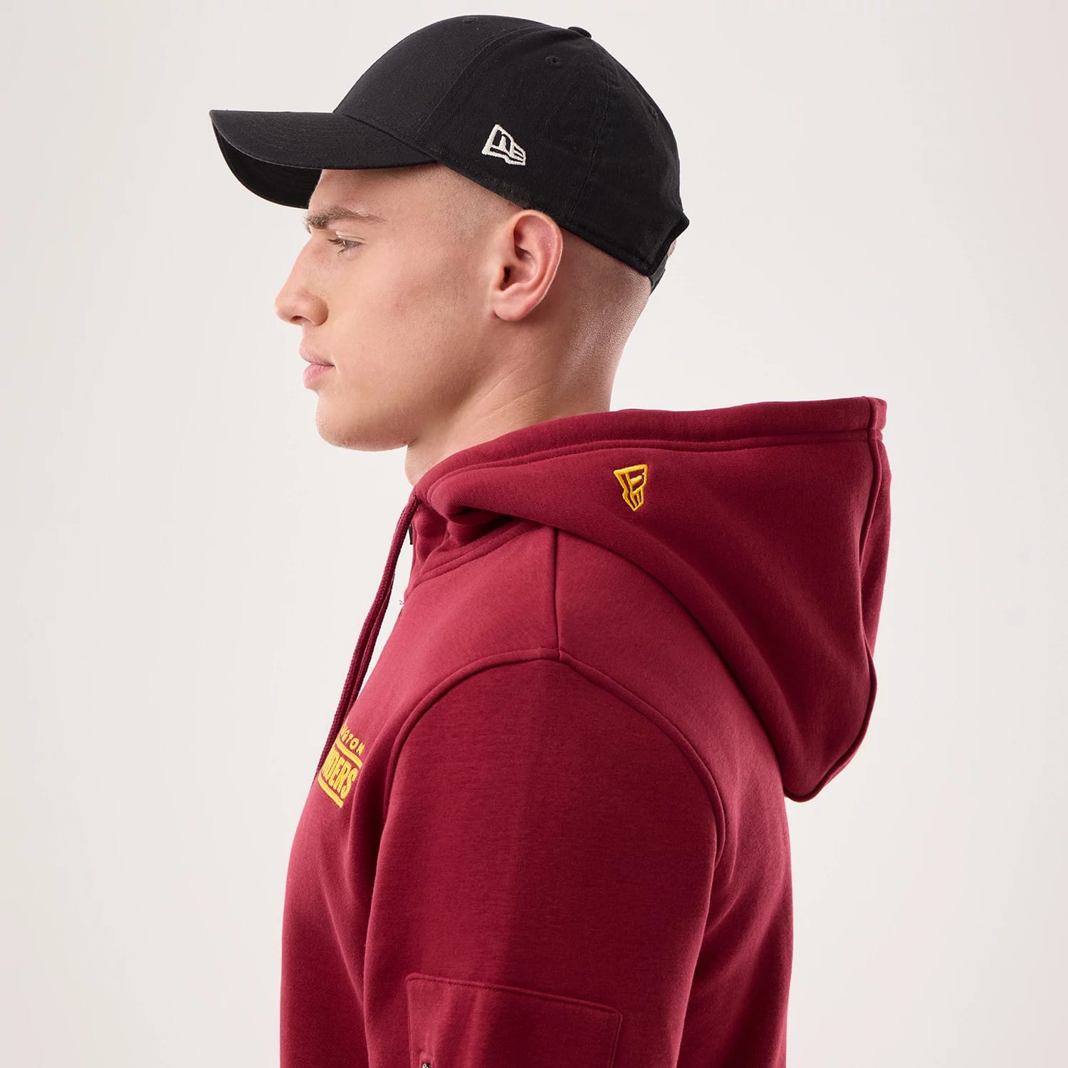 The model is wearing this NFL Sideline 2026 Washington Commanders Pullover Hoodie in dark red. 7