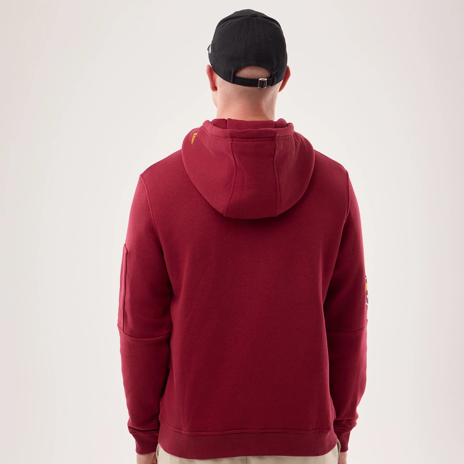 The model is wearing this NFL Sideline 2026 Washington Commanders Pullover Hoodie in dark red. 2
