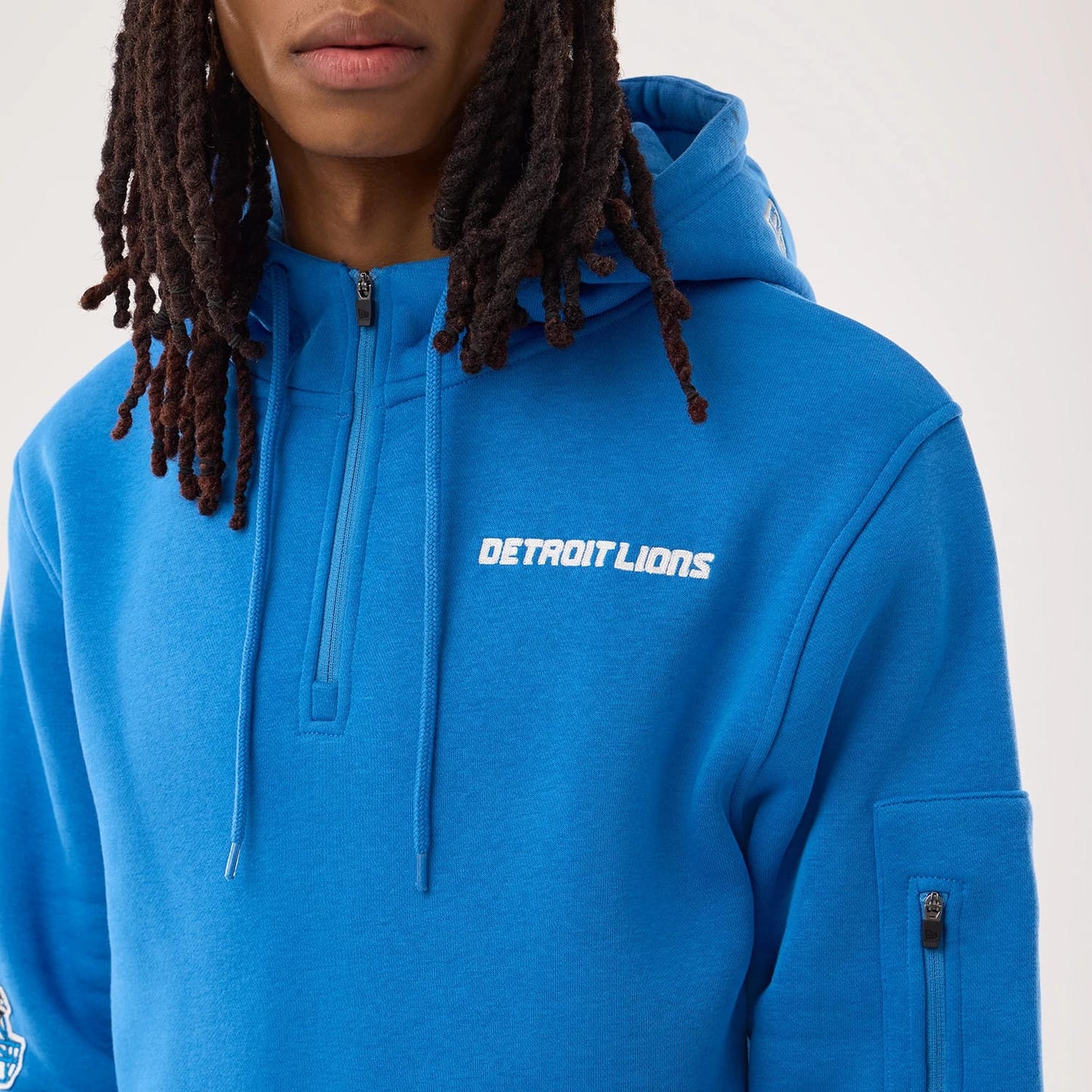 The model is wearing this NFL Sideline 2026 Detroit Lions Pullover Hoodie in blue. 3