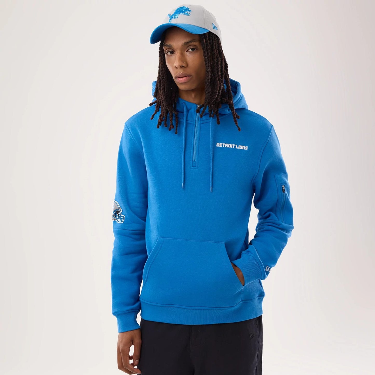 The model is wearing this NFL Sideline 2026 Detroit Lions Pullover Hoodie in blue. 1