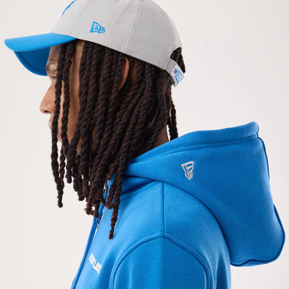 The model is wearing this NFL Sideline 2026 Detroit Lions Pullover Hoodie in blue. 7