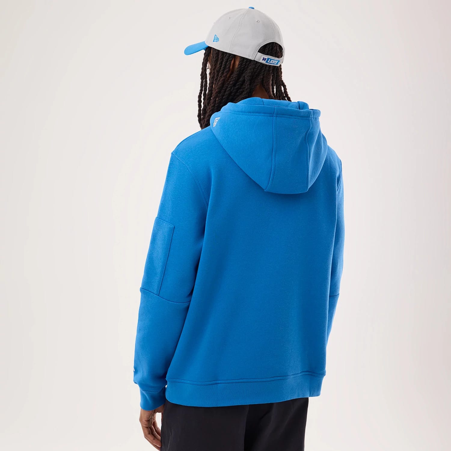 The model is wearing this NFL Sideline 2026 Detroit Lions Pullover Hoodie in blue. 2