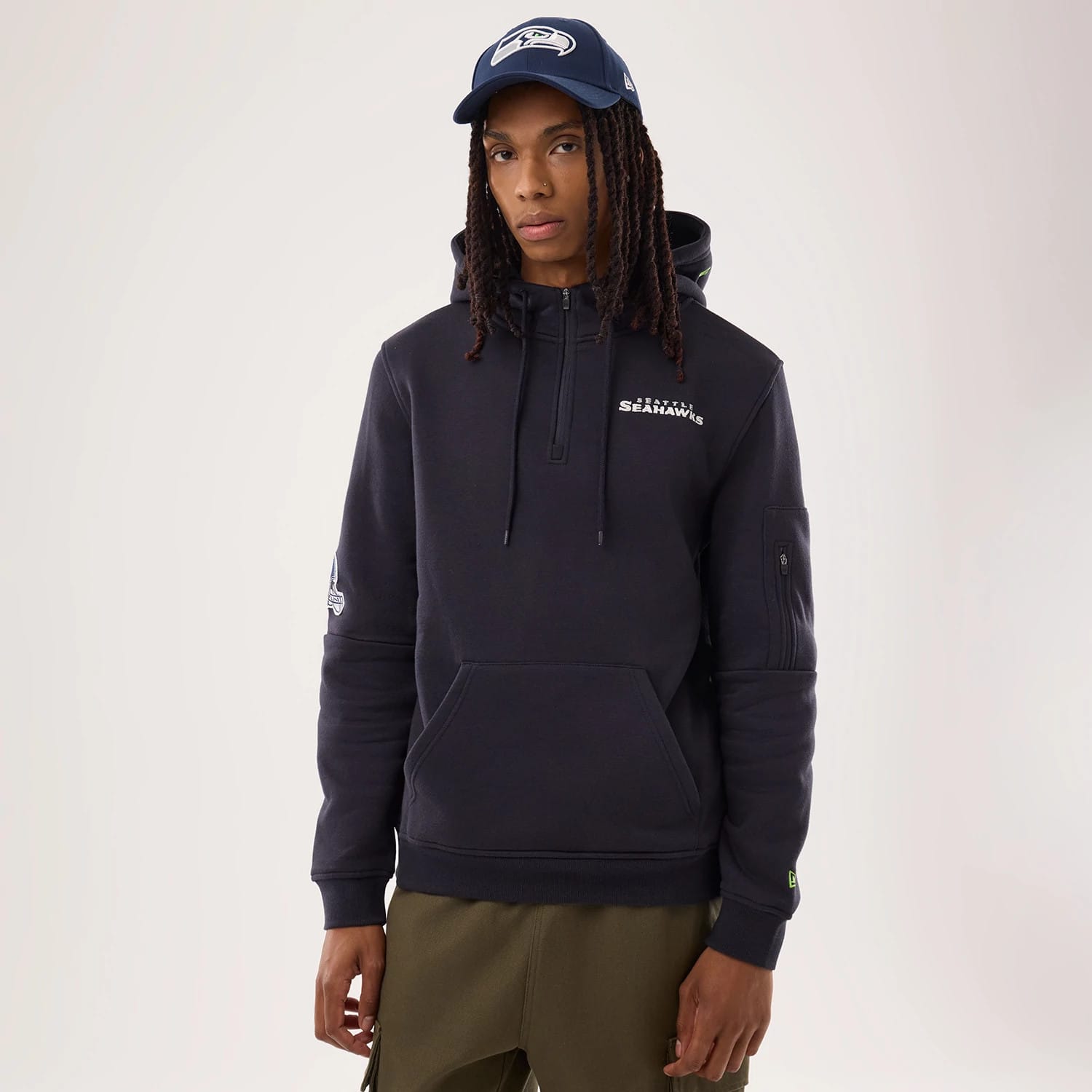 The model is wearing this NFL Sideline 2026 Seattle Seahawks Pullover Hoodie in navy. 1