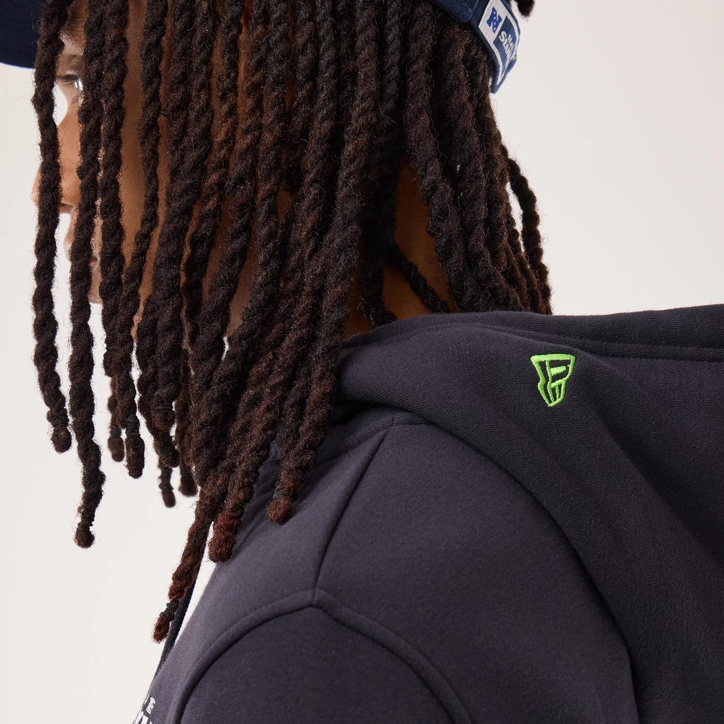 The model is wearing this NFL Sideline 2026 Seattle Seahawks Pullover Hoodie in navy. 5