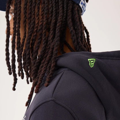 The model is wearing this NFL Sideline 2026 Seattle Seahawks Pullover Hoodie in navy. 5