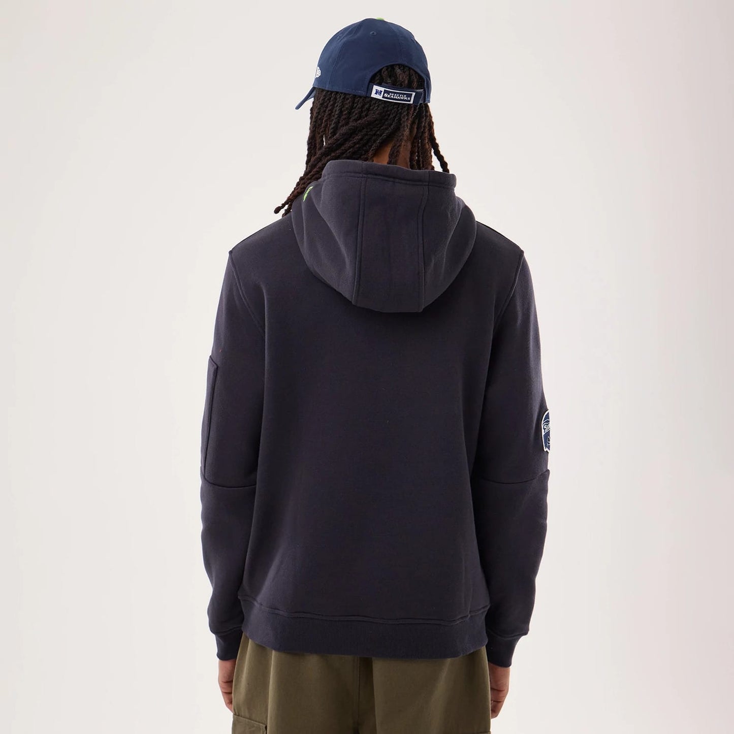 The model is wearing this NFL Sideline 2026 Seattle Seahawks Pullover Hoodie in navy. 2