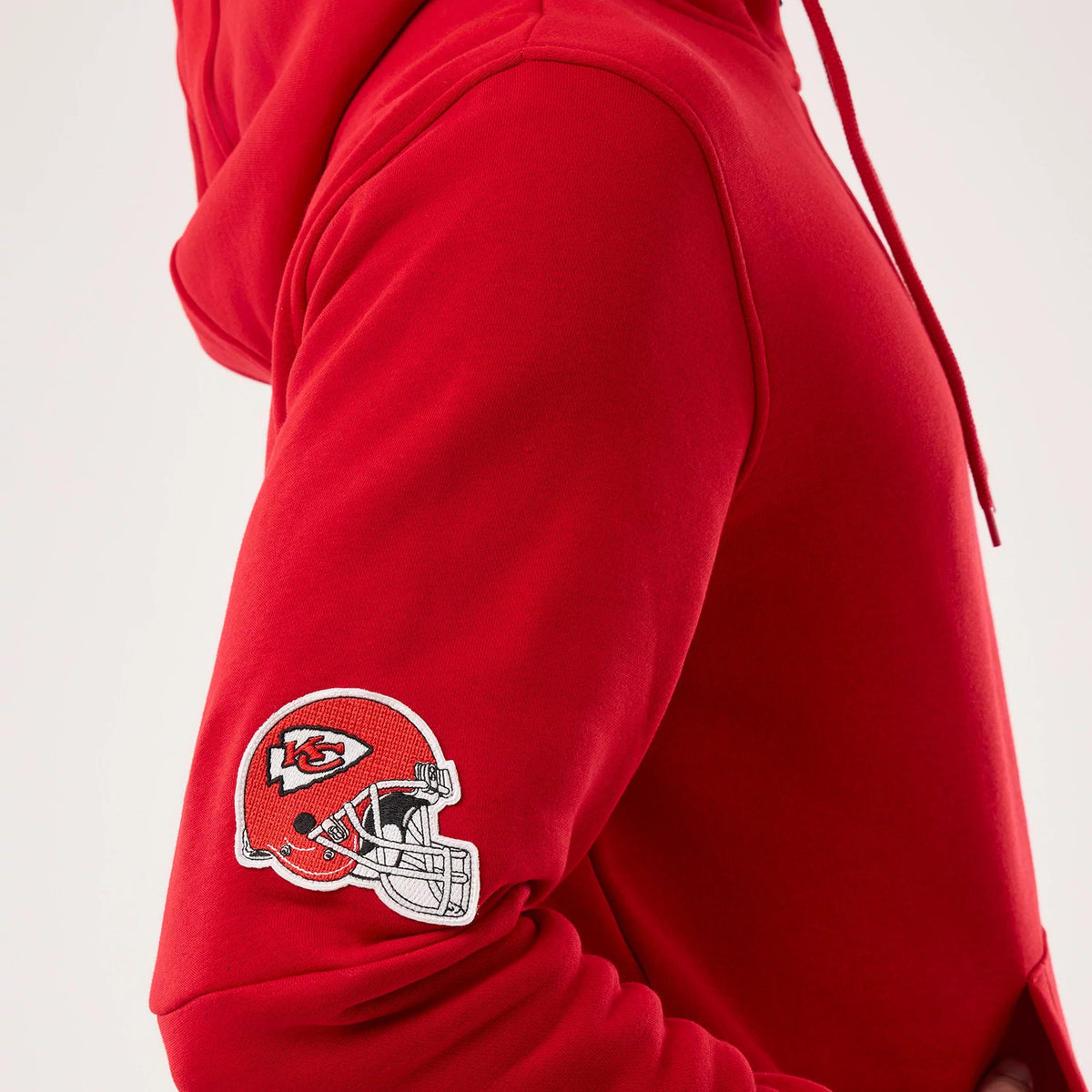The model is wearing this NFL Sideline 2026 Kansas City Chiefs Pullover Hoodie in red. 4