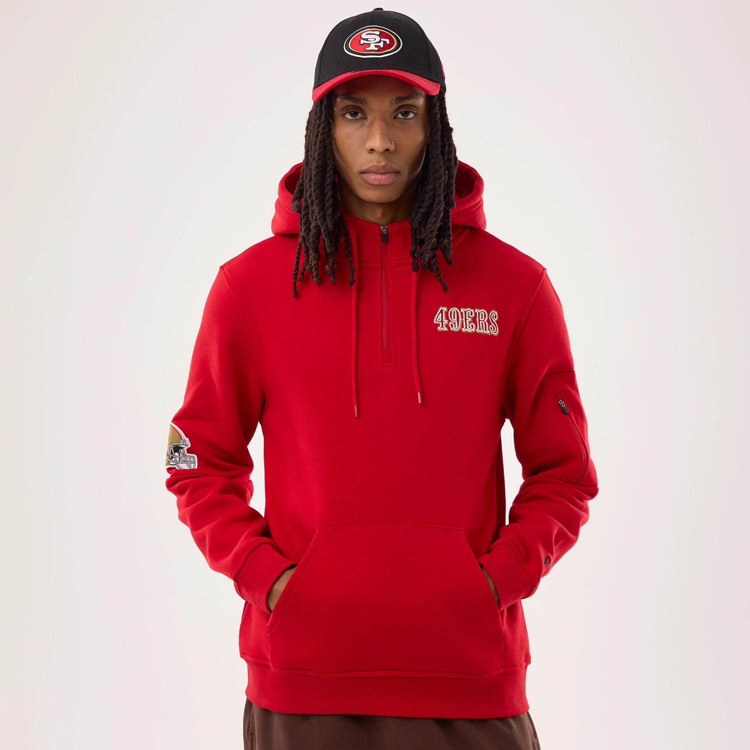 The model is wearing this NFL Sideline 2026 San Francisco 49ers Pullover Hoodie in red. 1