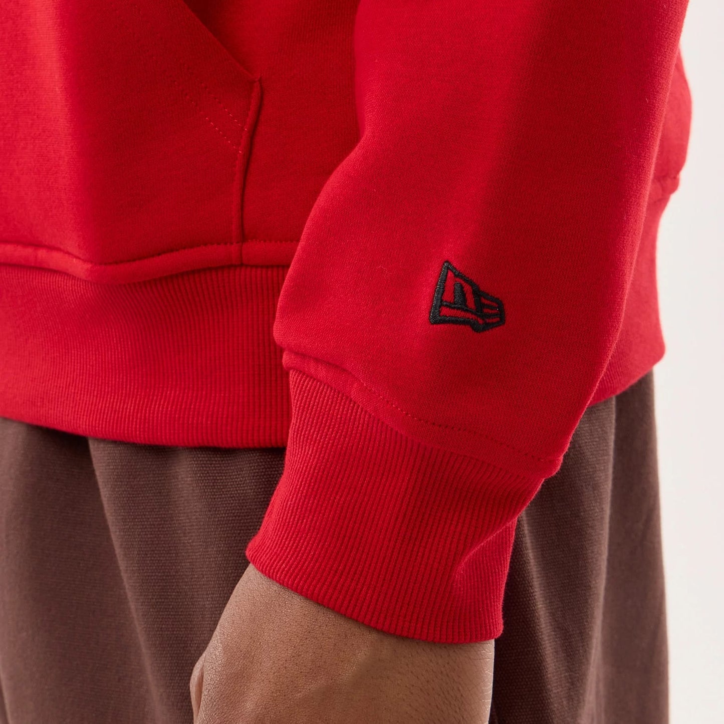 The model is wearing this NFL Sideline 2026 San Francisco 49ers Pullover Hoodie in red. 7