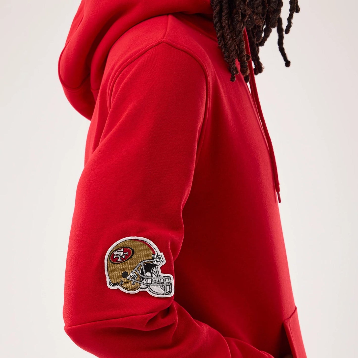 The model is wearing this NFL Sideline 2026 San Francisco 49ers Pullover Hoodie in red. 5