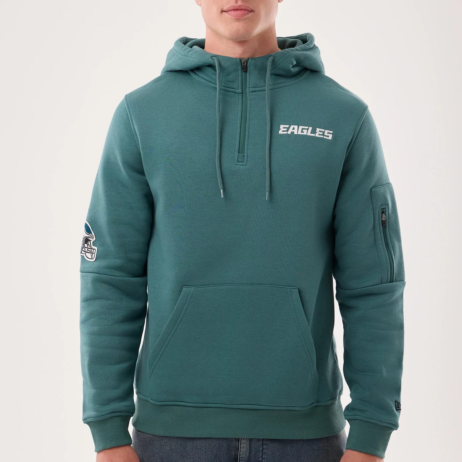 The model is wearing this NFL Sideline 2026 Philadelphia Eagles Pullover Hoodie in dark green. 3