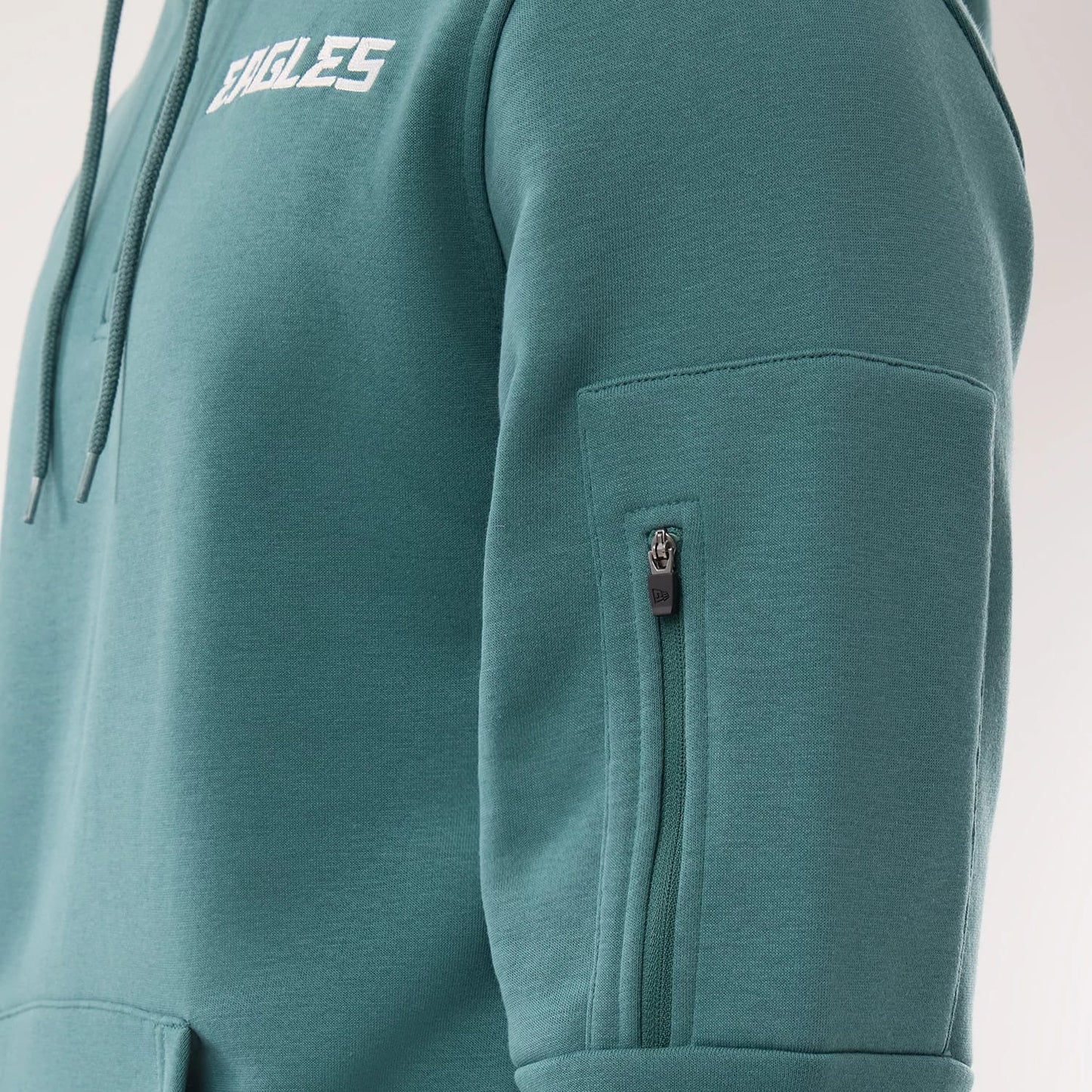 The model is wearing this NFL Sideline 2026 Philadelphia Eagles Pullover Hoodie in dark green. 4