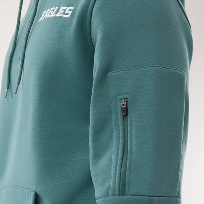 The model is wearing this NFL Sideline 2026 Philadelphia Eagles Pullover Hoodie in dark green. 4
