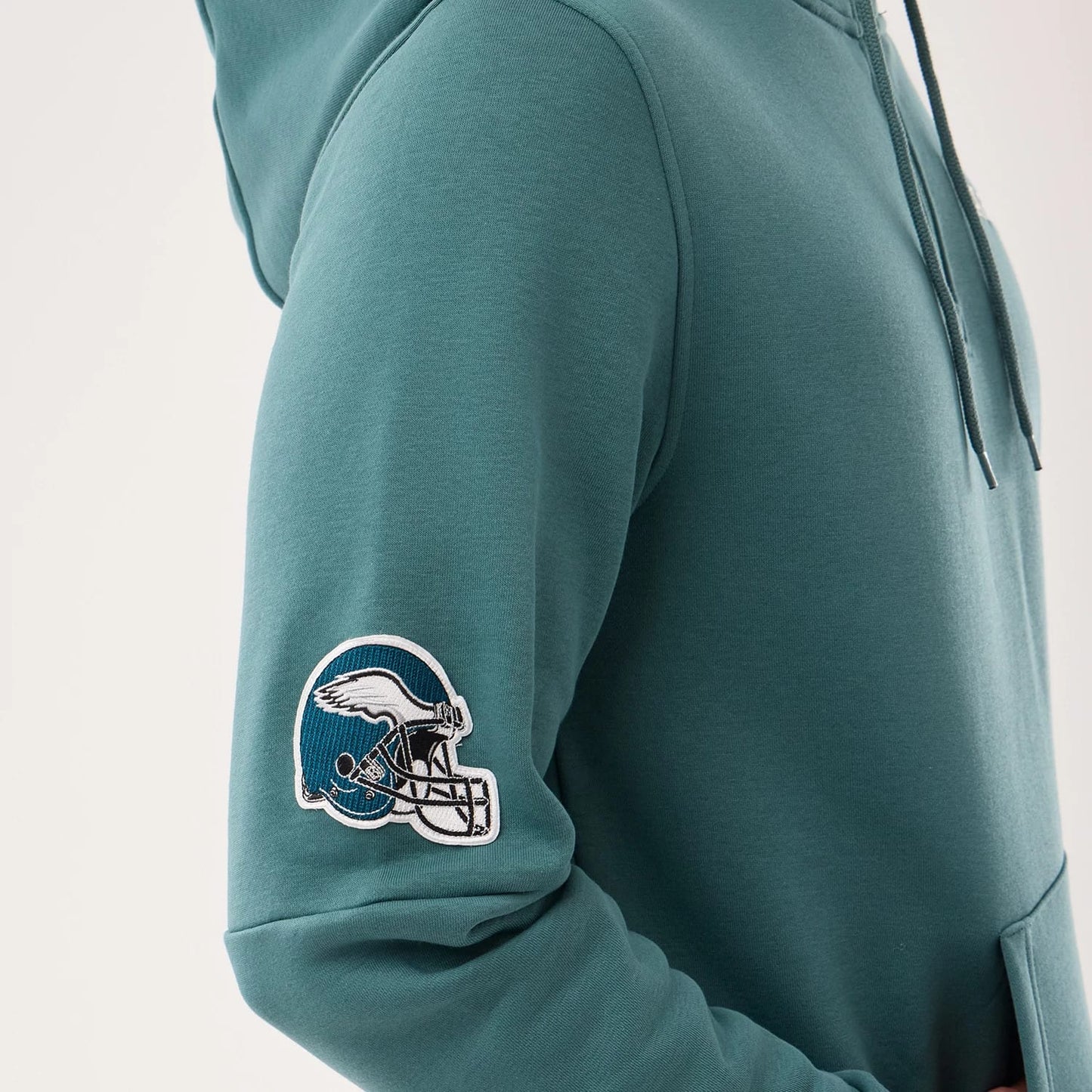 The model is wearing this NFL Sideline 2026 Philadelphia Eagles Pullover Hoodie in dark green. 6