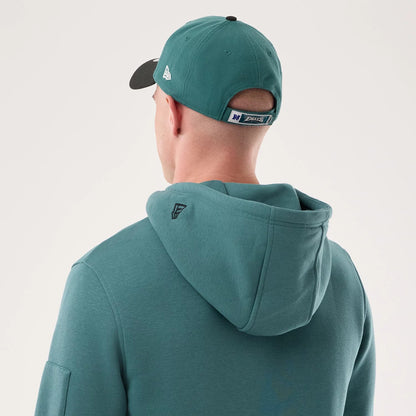 The model is wearing this NFL Sideline 2026 Philadelphia Eagles Pullover Hoodie in dark green. 7