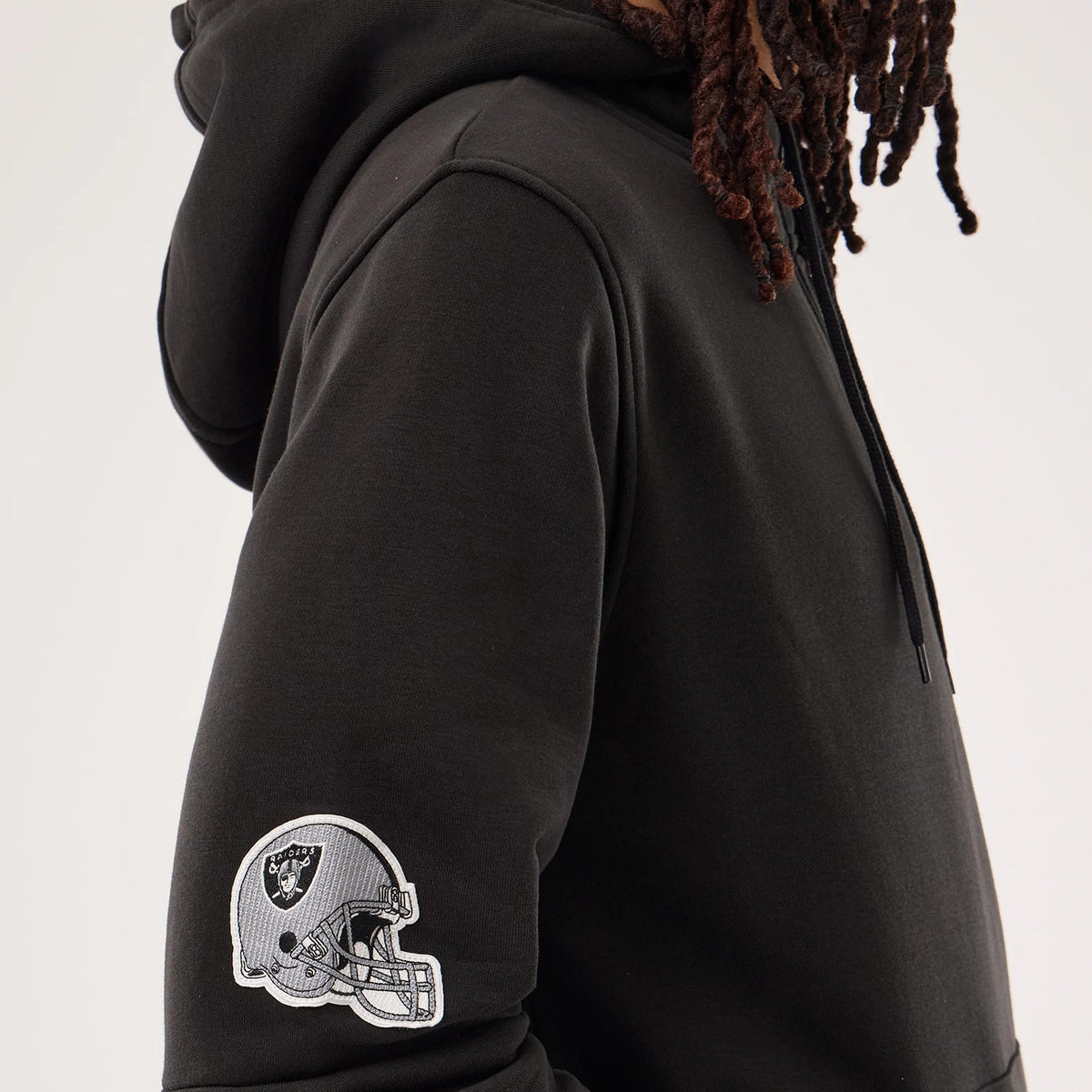 The model is wearing this NFL Sideline 2026 Las Vegas Raiders Pullover Hoodie in black. 6