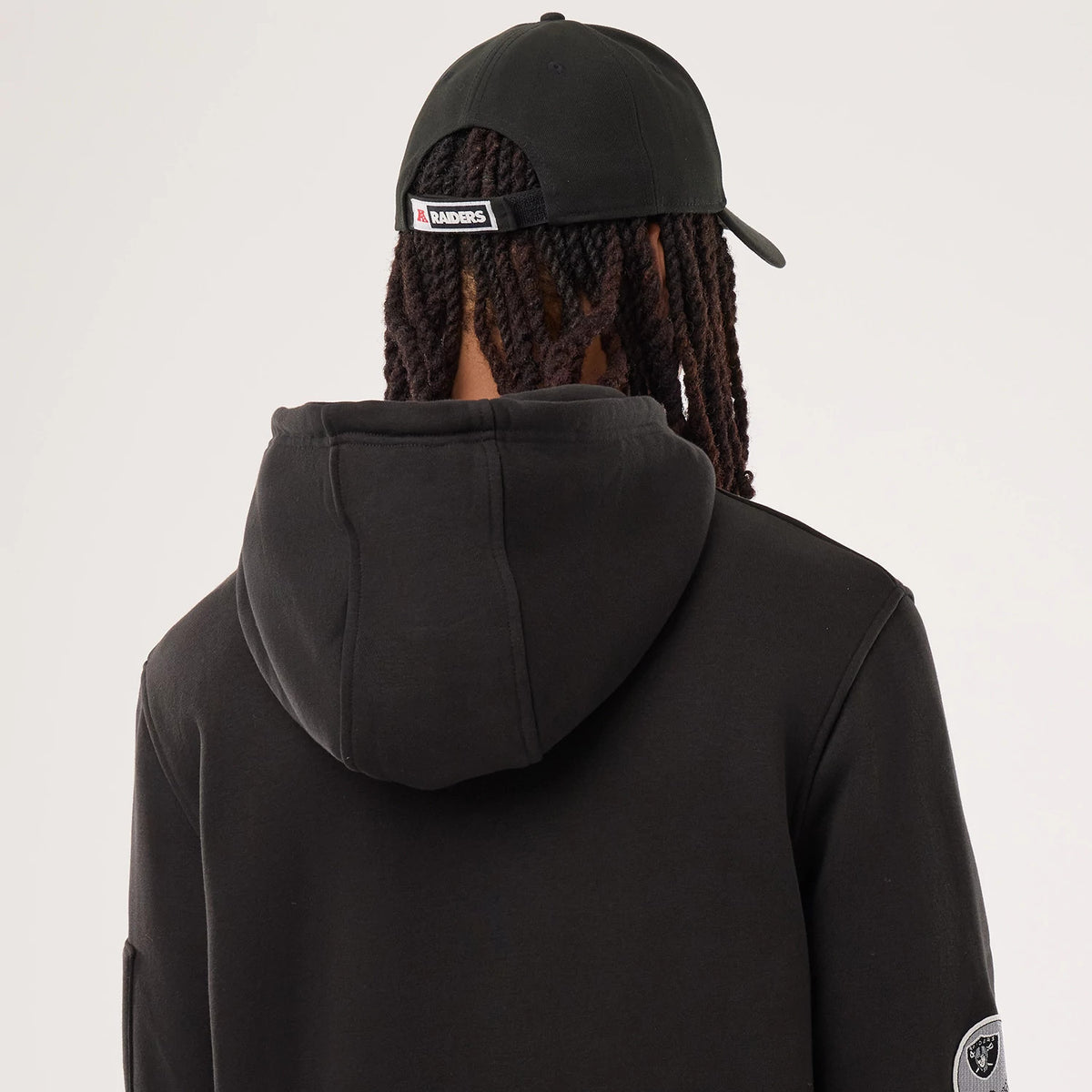 The model is wearing this NFL Sideline 2026 Las Vegas Raiders Pullover Hoodie in black. 5