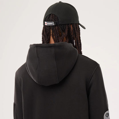The model is wearing this NFL Sideline 2026 Las Vegas Raiders Pullover Hoodie in black. 5
