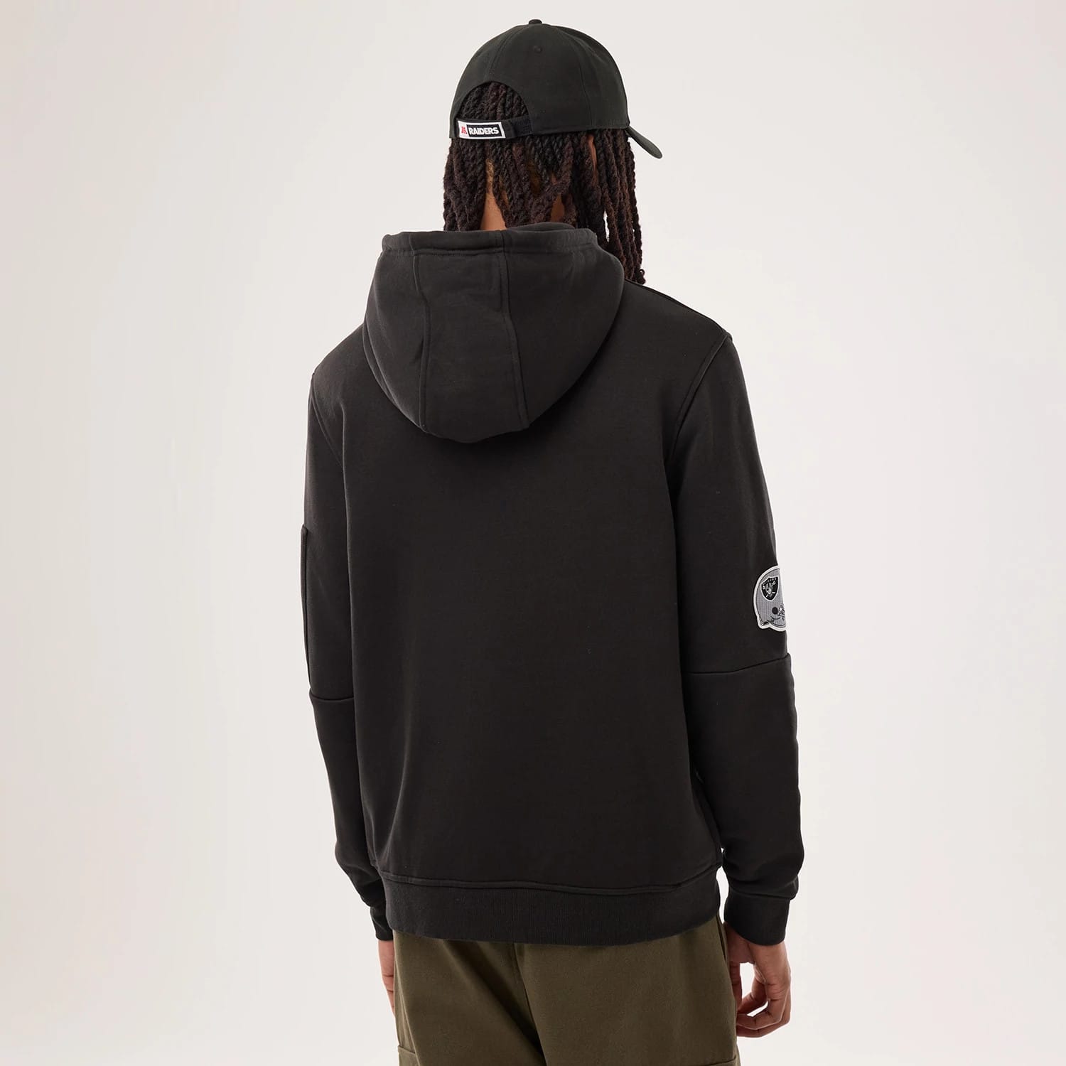 The model is wearing this NFL Sideline 2026 Las Vegas Raiders Pullover Hoodie in black. 2