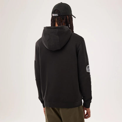 The model is wearing this NFL Sideline 2026 Las Vegas Raiders Pullover Hoodie in black. 2