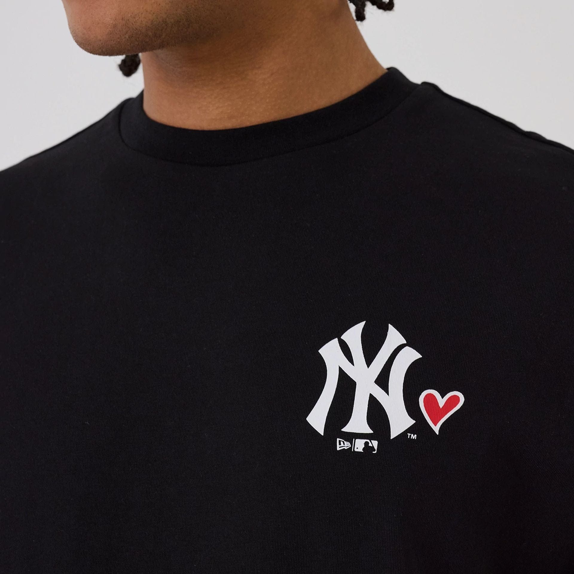 The model is wearing this MLB Heart Graphic New York Yankees T-Shirt in black. 3