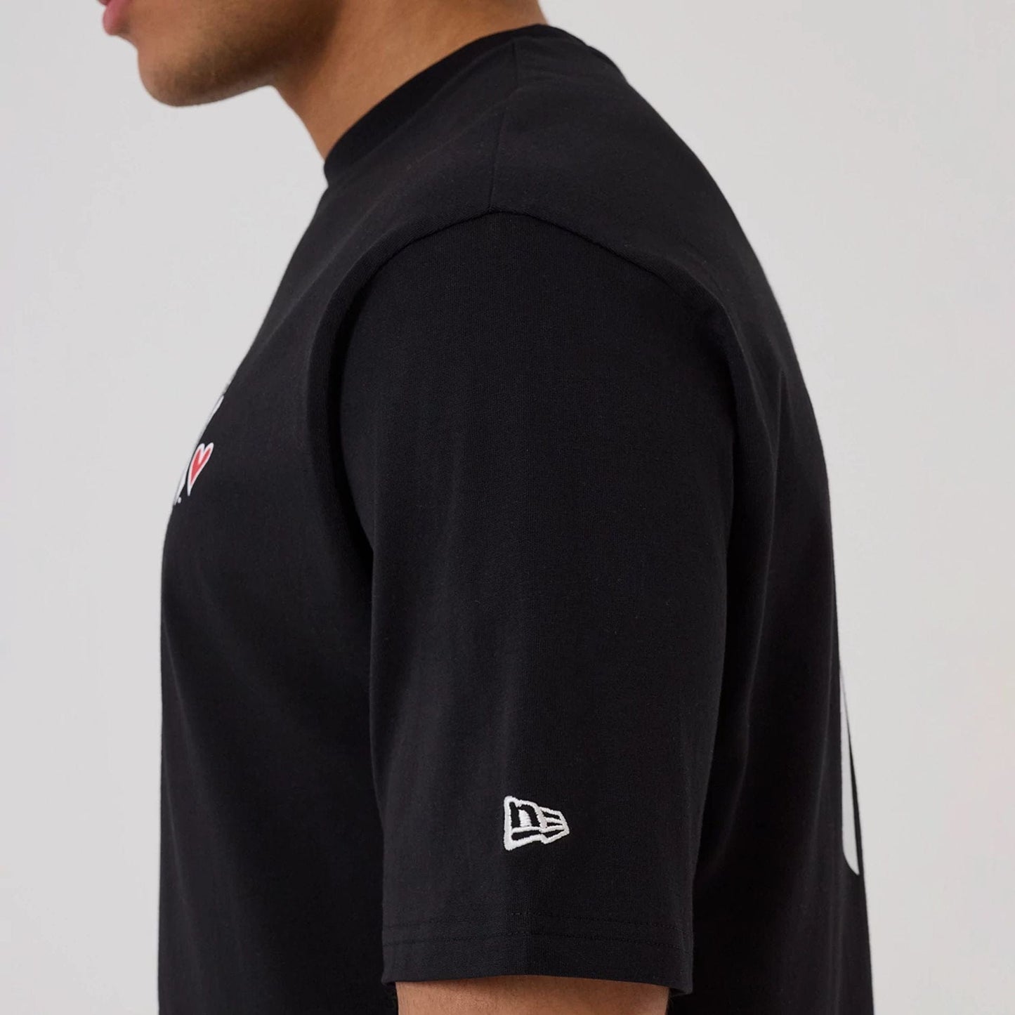 The model is wearing this MLB Heart Graphic New York Yankees T-Shirt in black. 5