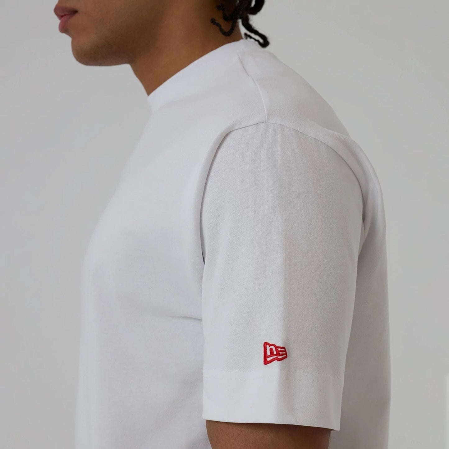 The model is wearing this New Era Love Graphic T-Shirt in white. 6