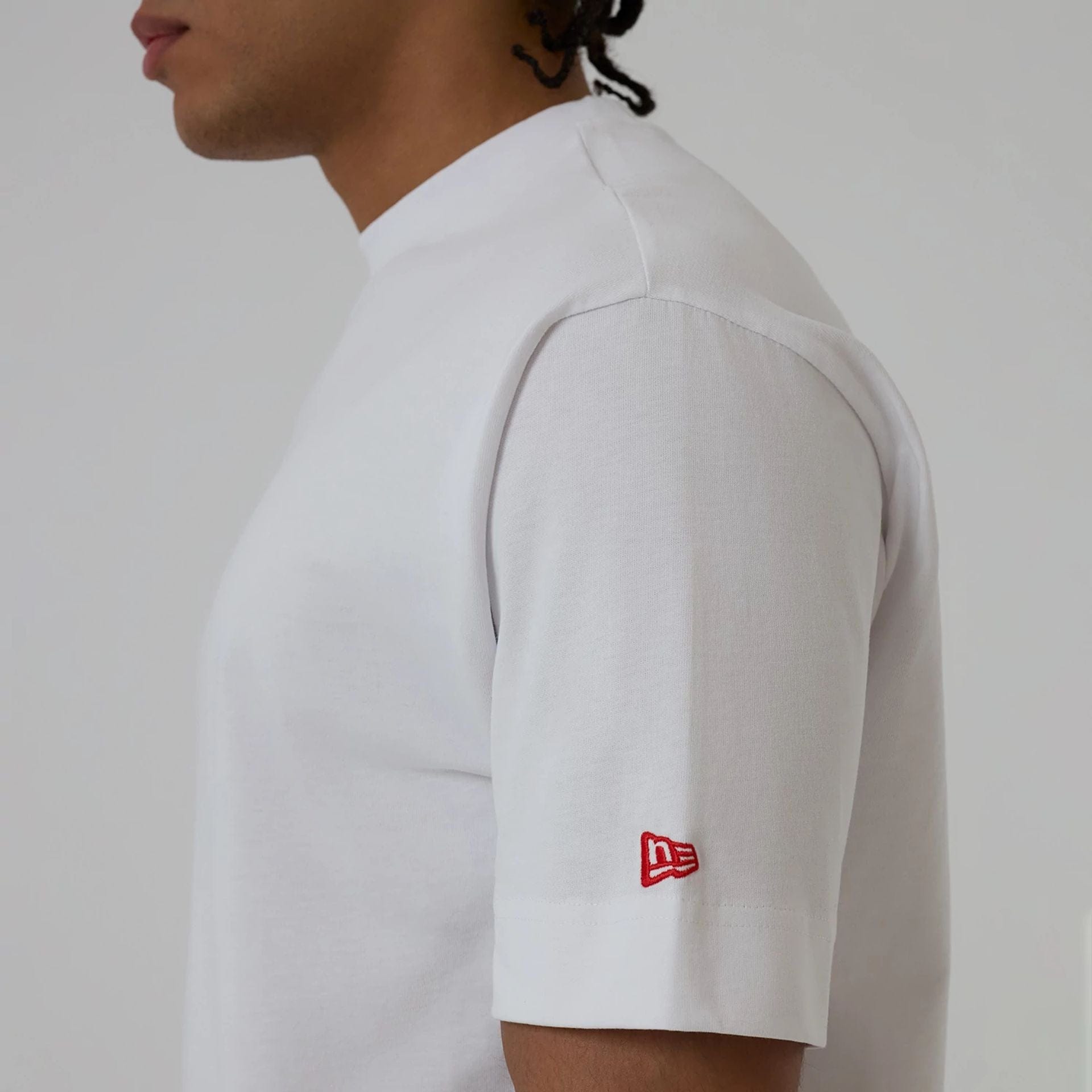 The model is wearing this New Era Love Graphic T-Shirt in white. 6