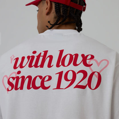 The model is wearing this New Era Love Graphic T-Shirt in white. 5