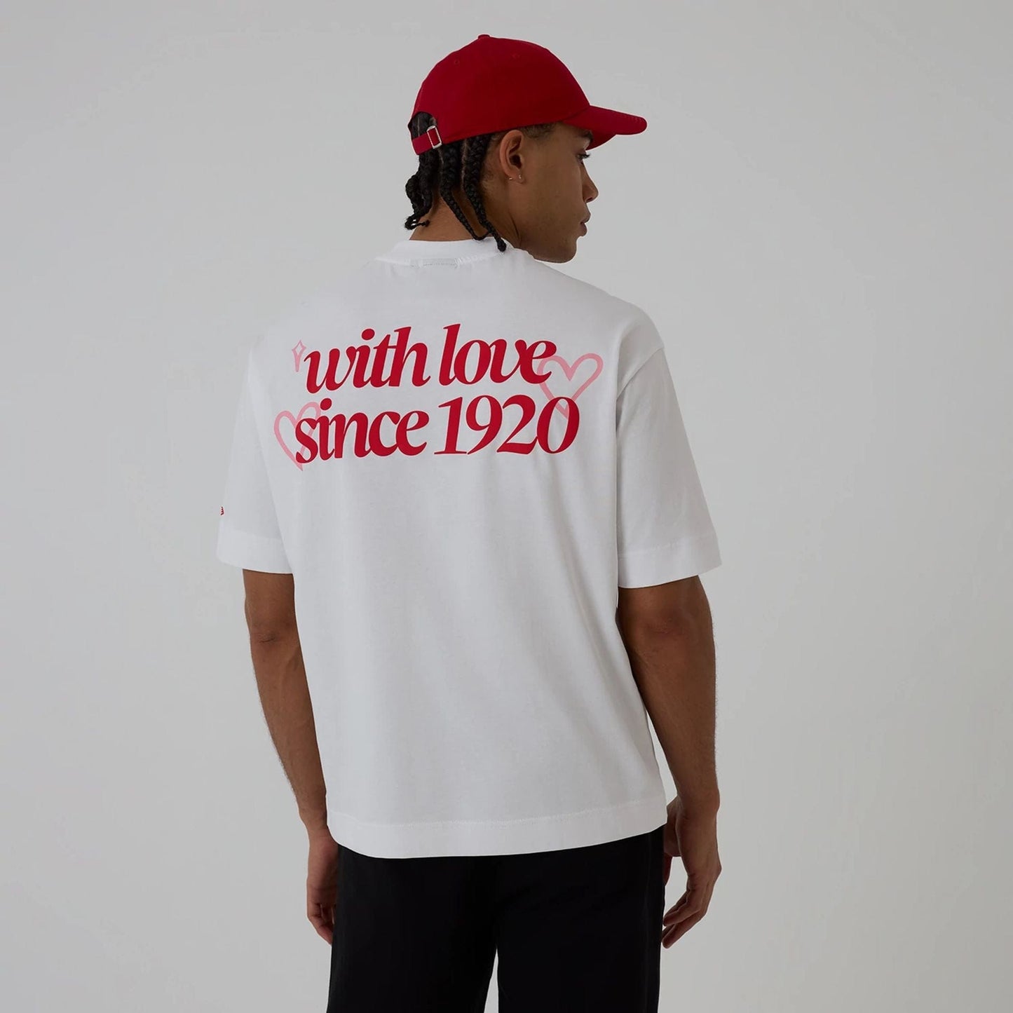 The model is wearing this New Era Love Graphic T-Shirt in white. 2
