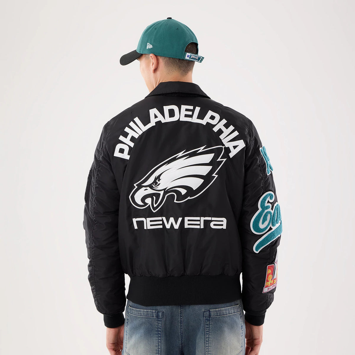 The model is wearing this NFL X Alpha Philadelphia Eagles Jacket in Black. 2
