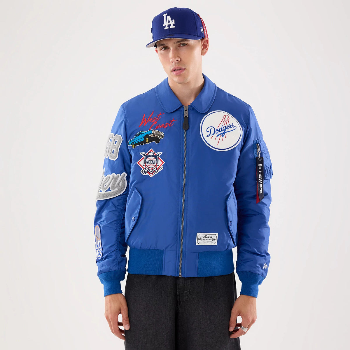 The model is wearing this MLB X Alpha LA Dodgers Jacket in Blue. 7