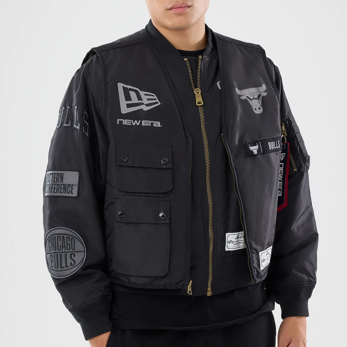 The model is wearing this NBA X Alpha Chicago Bulls Bomber Jacket & Tactical Vest in black. 3